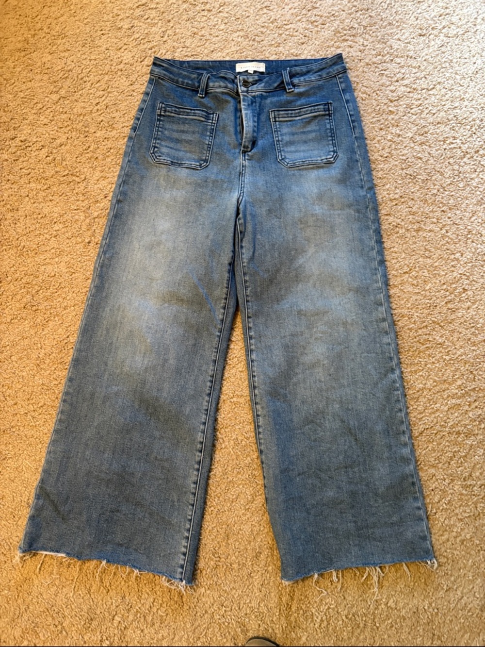 Risen High-Rise Wide-Leg Jeans in Medium Blue Wash - raw hem